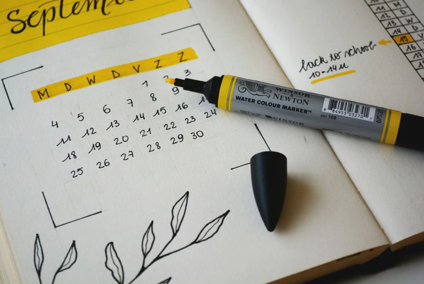 Calendar spread on a desk with markers, used for tracking physical presence days in Canada