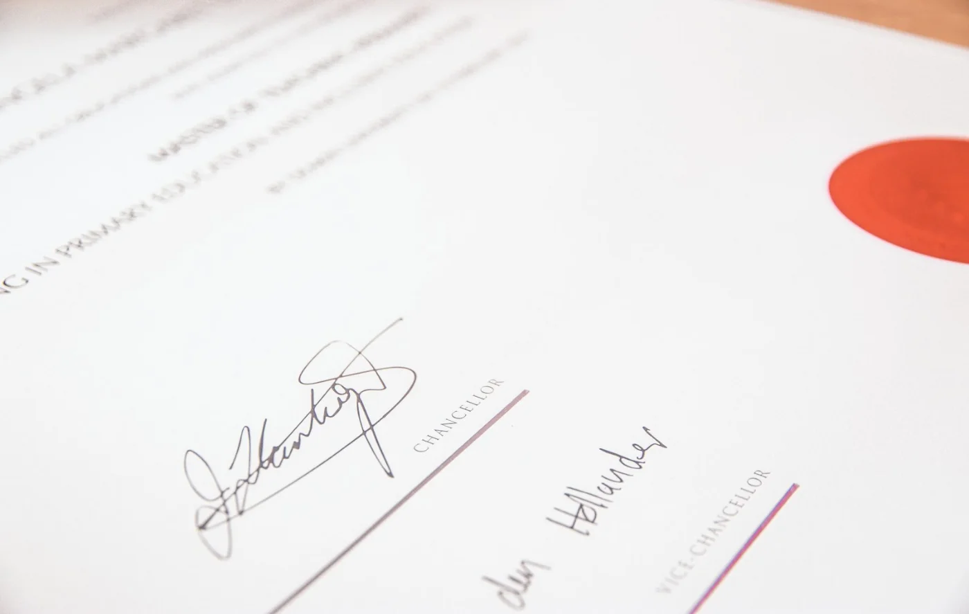 Hand stamping an official document, representing the certification of Canadian citizenship