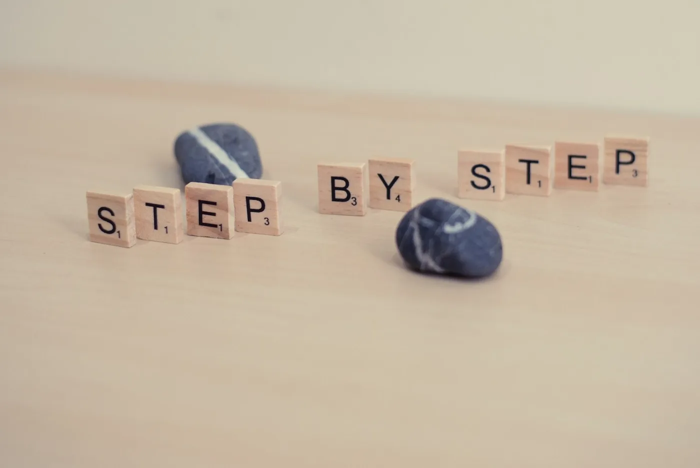 Hand stacking wooden blocks representing step by step CRS score calculation