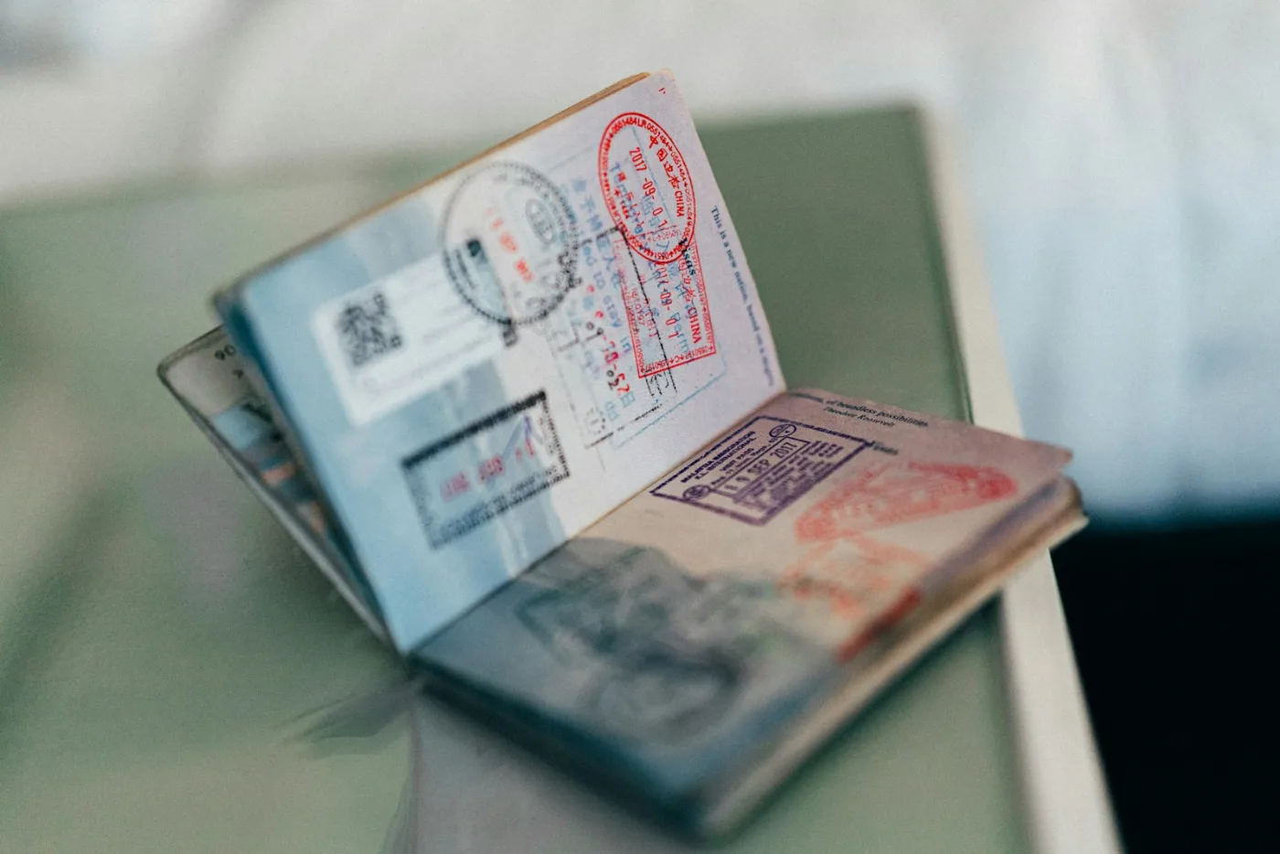 Passport and resume on a desk representing documents needed to calculate a CRS score