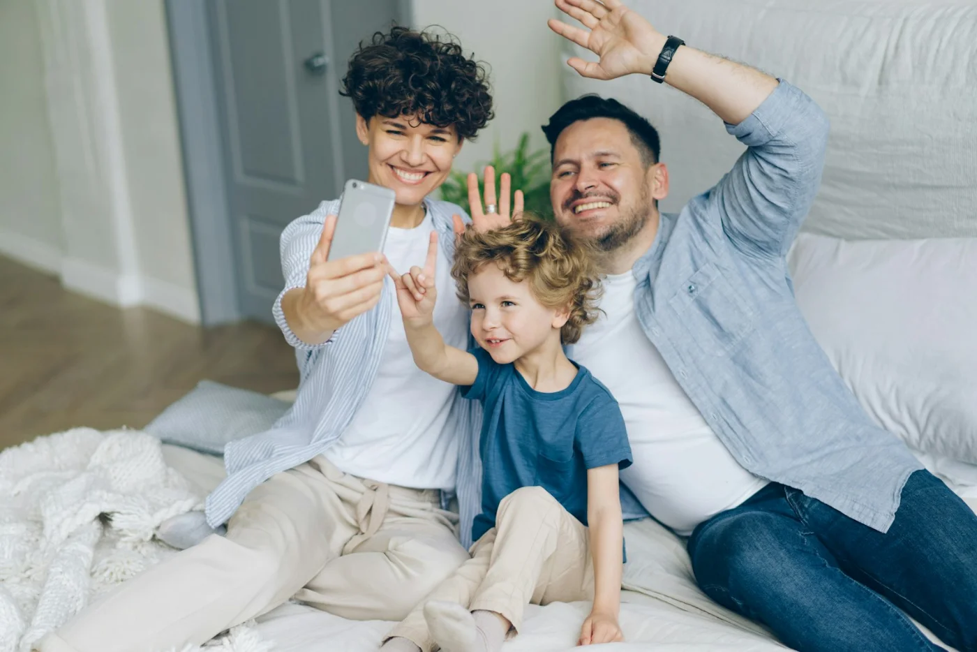 Happy family laughing together at home, celebrating their Permanent Resident approval in Canada