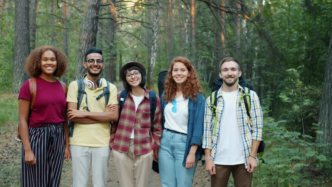 Group of young friends celebrating outdoors, representing the social side of a working holiday in Canada