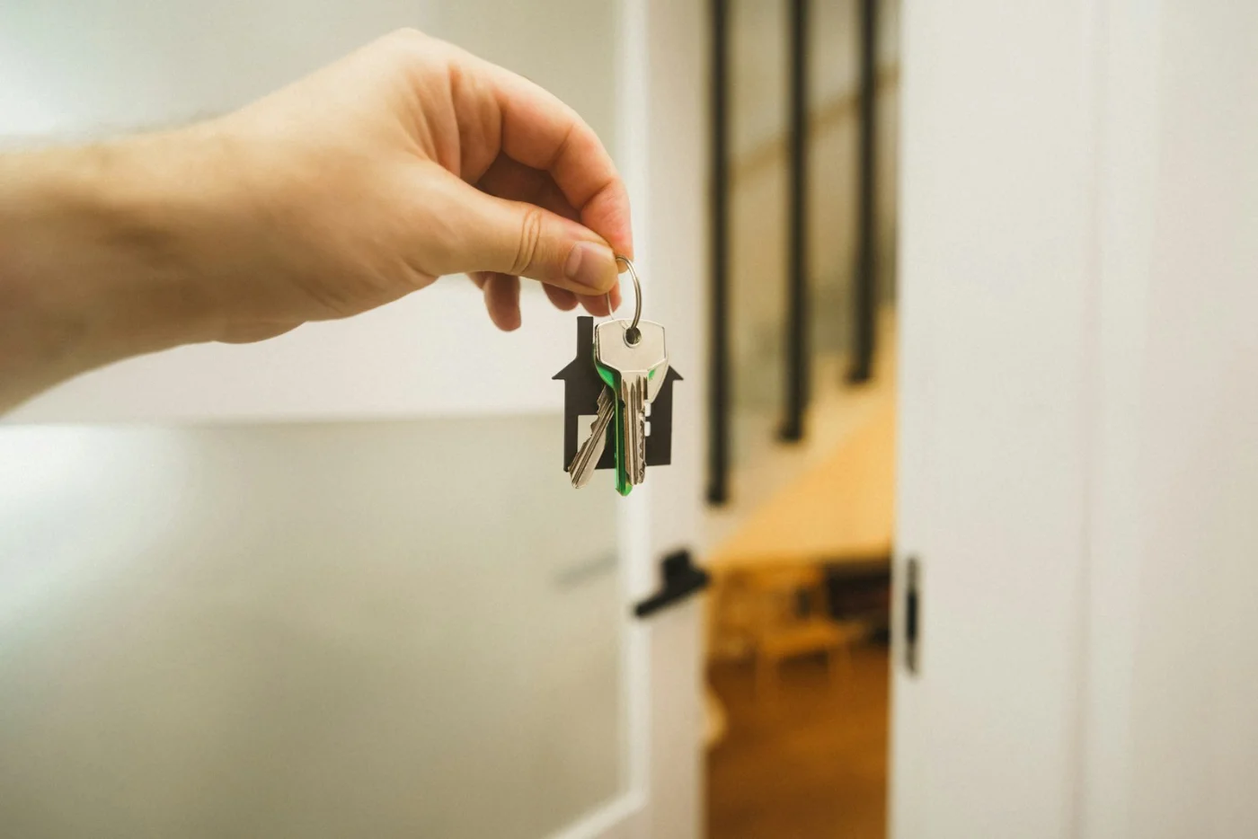 Woman holding house keys after settling into a new home in Canada