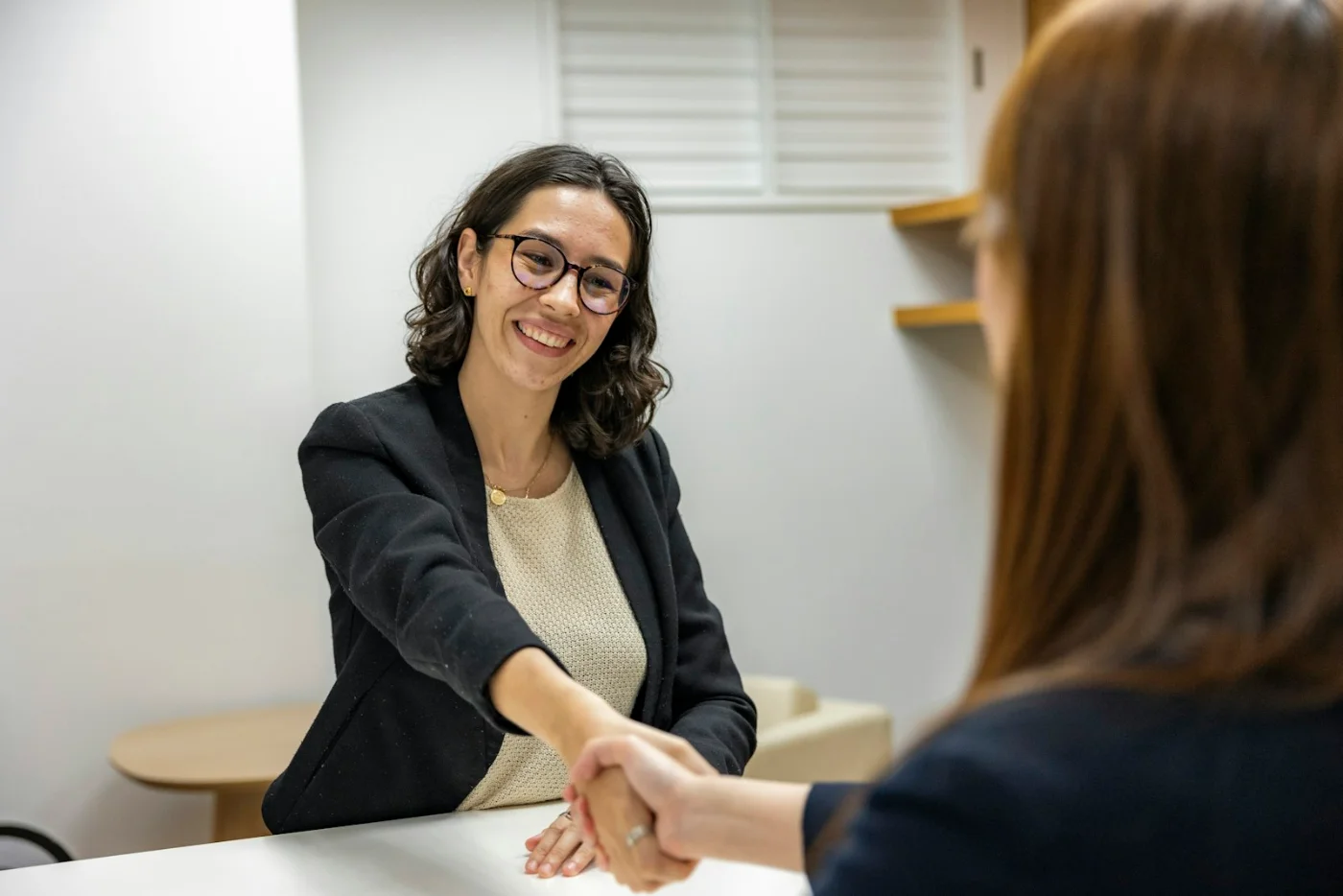 Business handshake representing a confirmed job offer for the Canada Skilled Worker Program