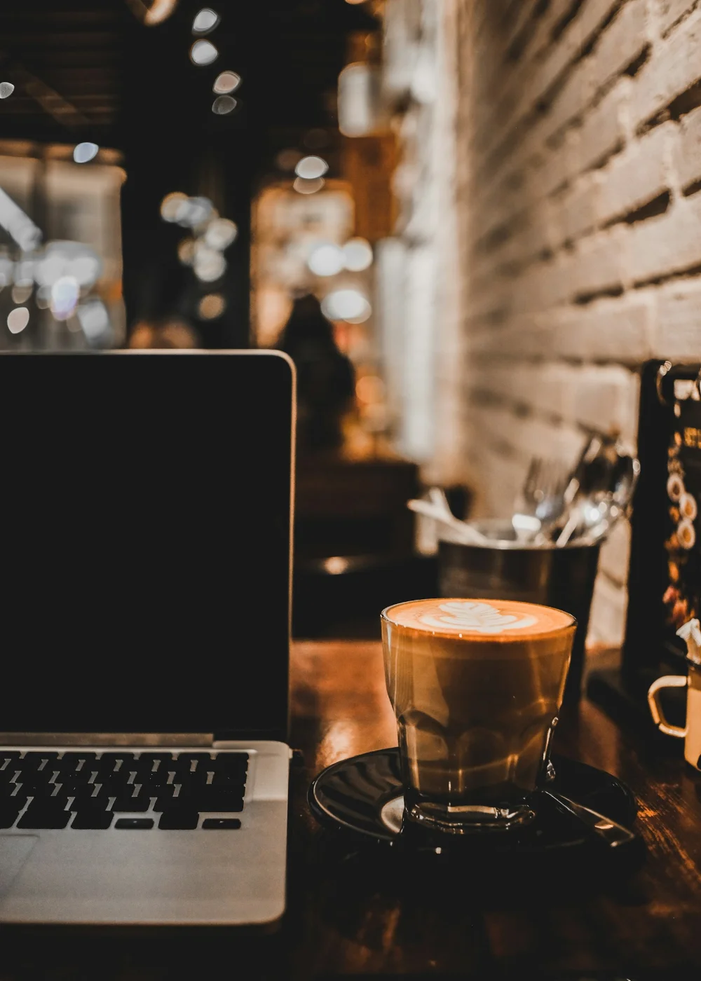 Laptop and coffee on a desk, symbolizing research into Canada Express Entry draw predictions