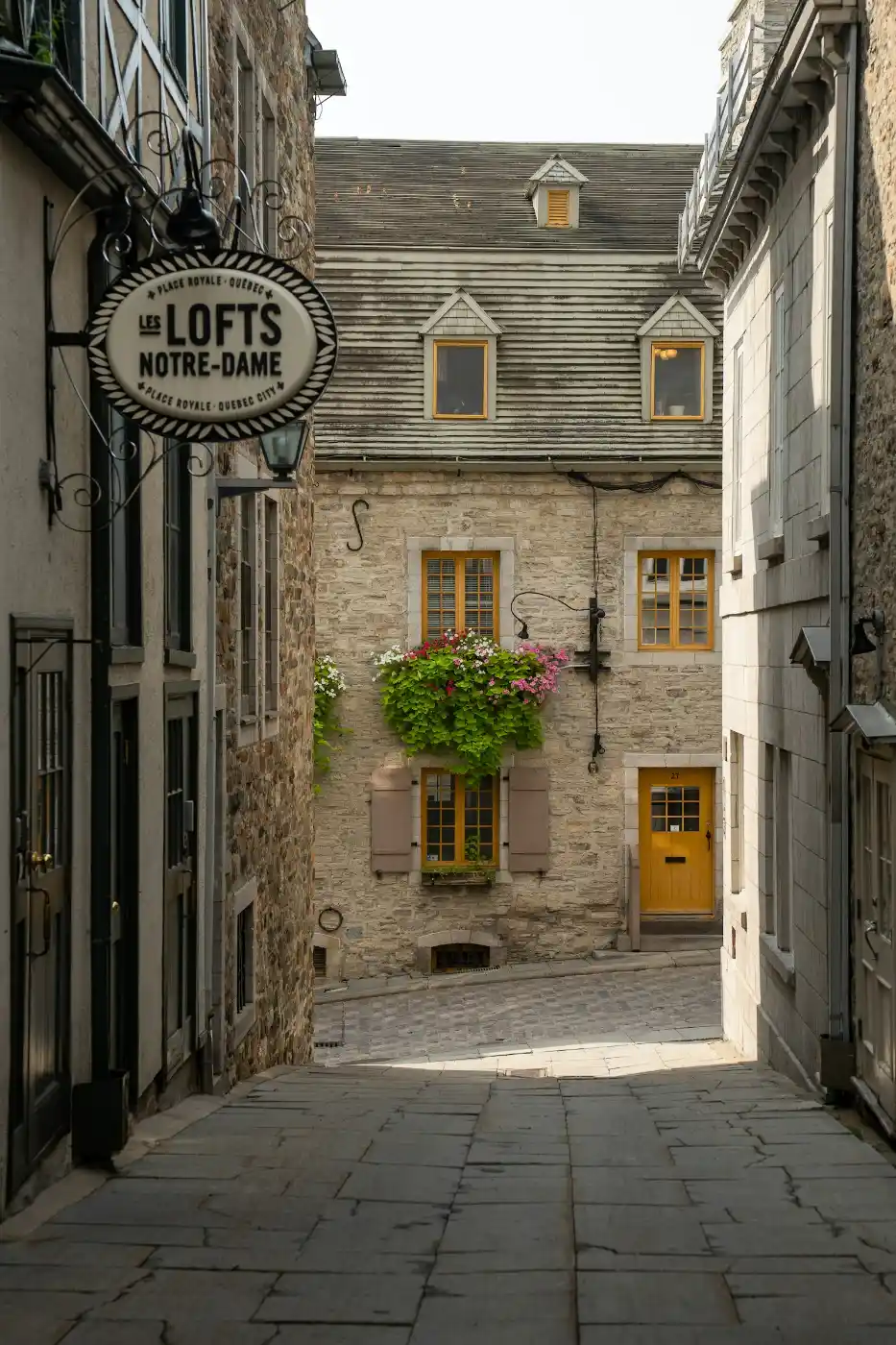 Historic cobblestone street lined with cafes in Old Quebec