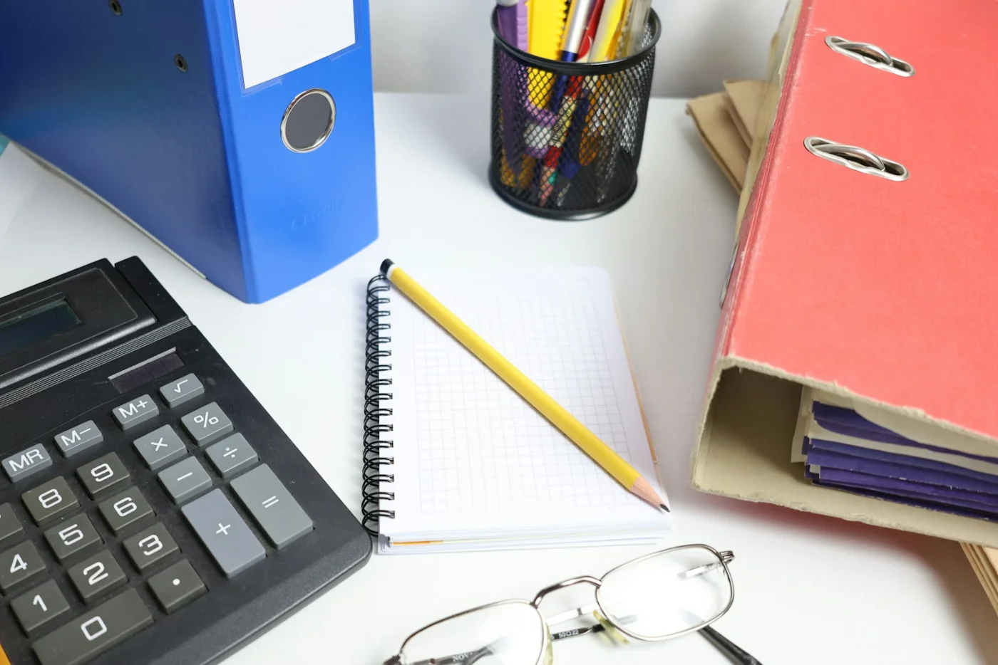 Neatly organized desk with a laptop and notebook, representing our organized resources
