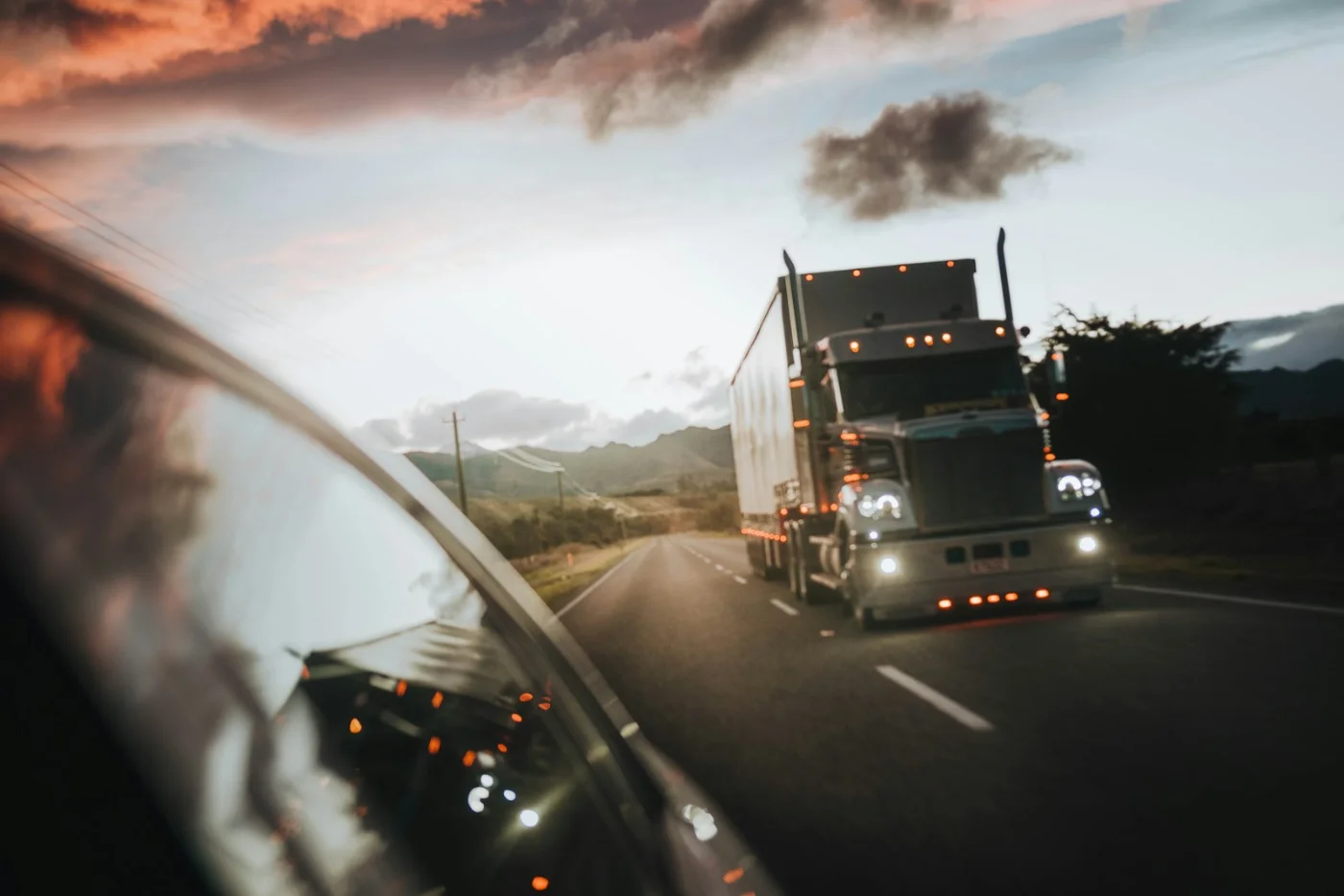 Moving truck on the highway, representing an H-1B worker relocating from the US to Canada