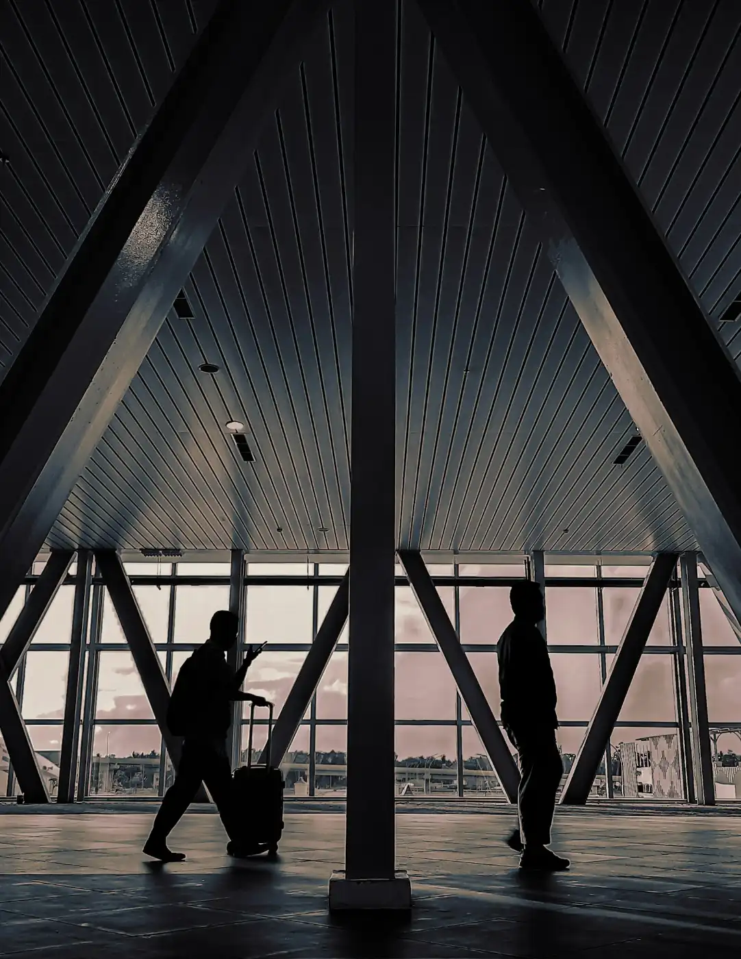 Senior couple walking through an airport terminal, traveling to visit family in Canada