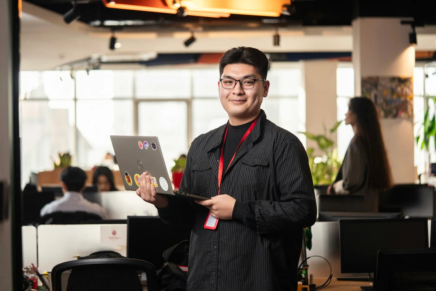 Smiling professional worker in an office setting, representing skilled worker visa applicants