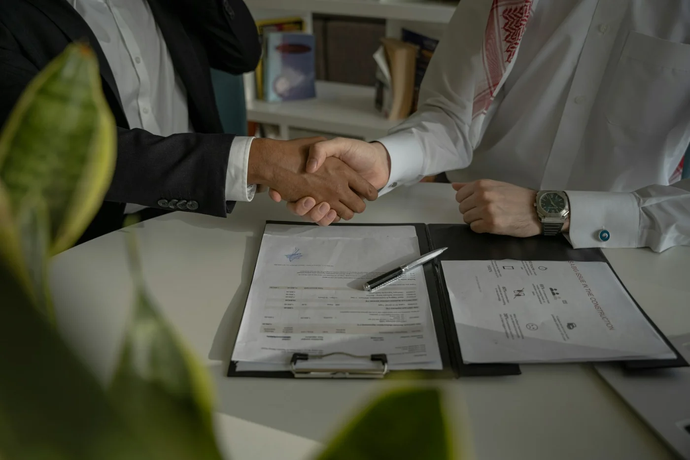 Business handshake representing the trust and transparency behind About CRS Calculator