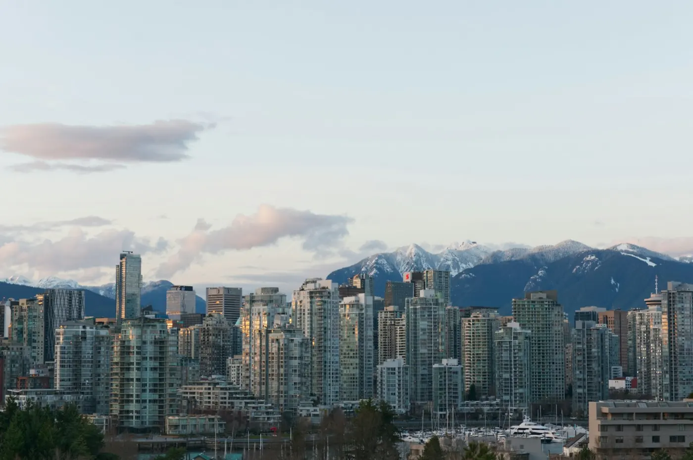 Vancouver skyline with mountains, a popular Canadian city for UK immigrants
